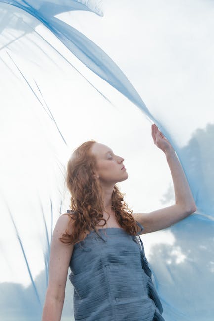 Woman performing a calm yoga pose outdoors with soft natural light